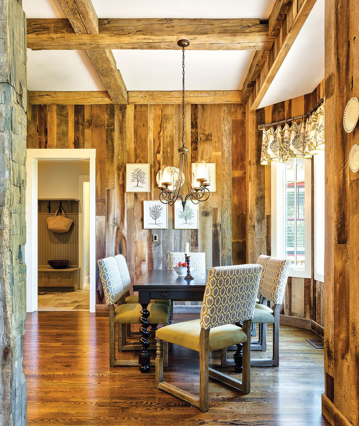 Reclaimed timber from Appalachian Antique Hardwoods figures prominently on the walls, columns and beams in the main living areas. Stained white oak floors from Gennett Lumber and Hardwood Flooring in Asheville adds to the warmth of the dining area.