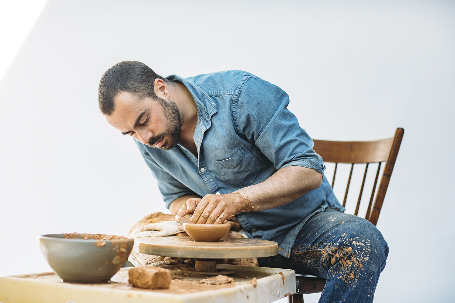 Alex Matisse and some of East Fork Pottery’s new line of dinnerware. Photo by Tim Robison