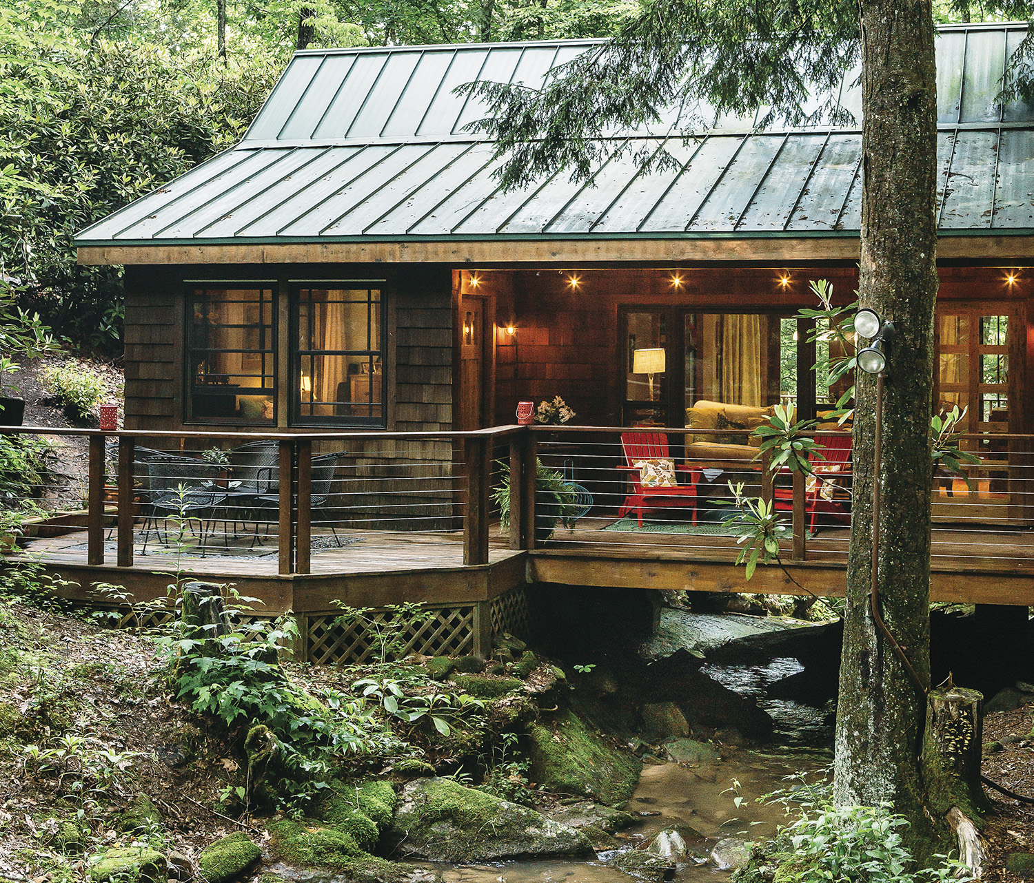 Laura and Matt Belanger’s secluded home boasts an 800-square-foot deck overlooking the creek. Photo by Tim Robison
