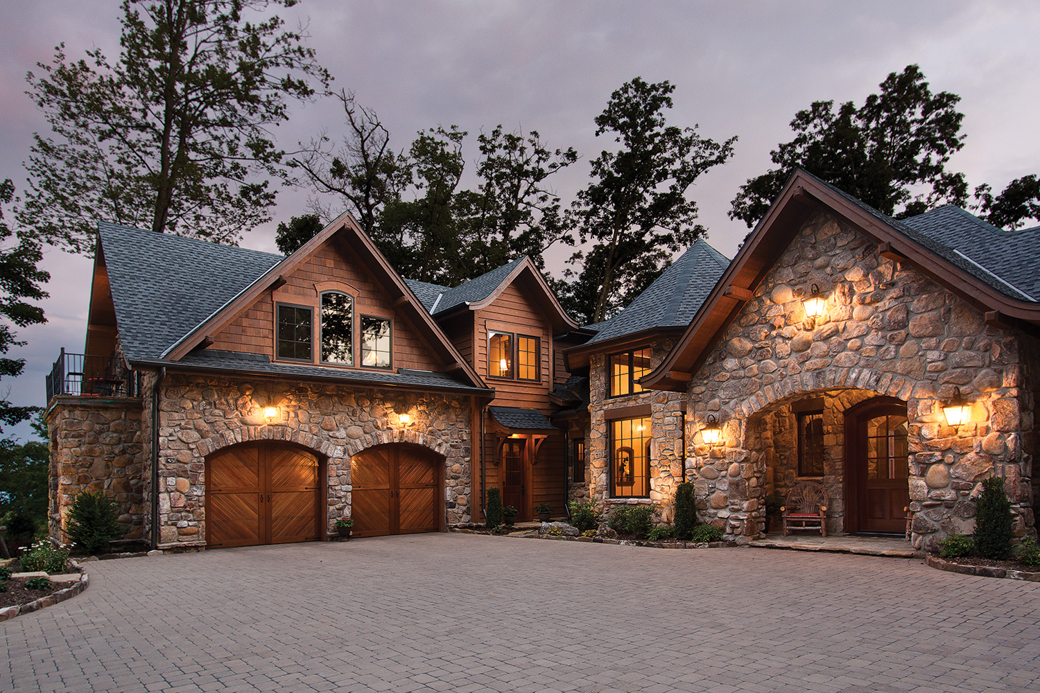 Both inside and out, stone takes center stage at the Stahl residence. Flying eaves and curved arches are repeated throughout the design. From the stonework to the rooflines, these details give the residence a grand cottage feel. Construction by Morgan-Keefe Builders, Arden. Custom carpentry by Square Peg Construction. Design by Cornerstone Design Studio, Atlanta. Steep Creek Stoneworks of Brevard laid the stonework. Photo by J. Weiland