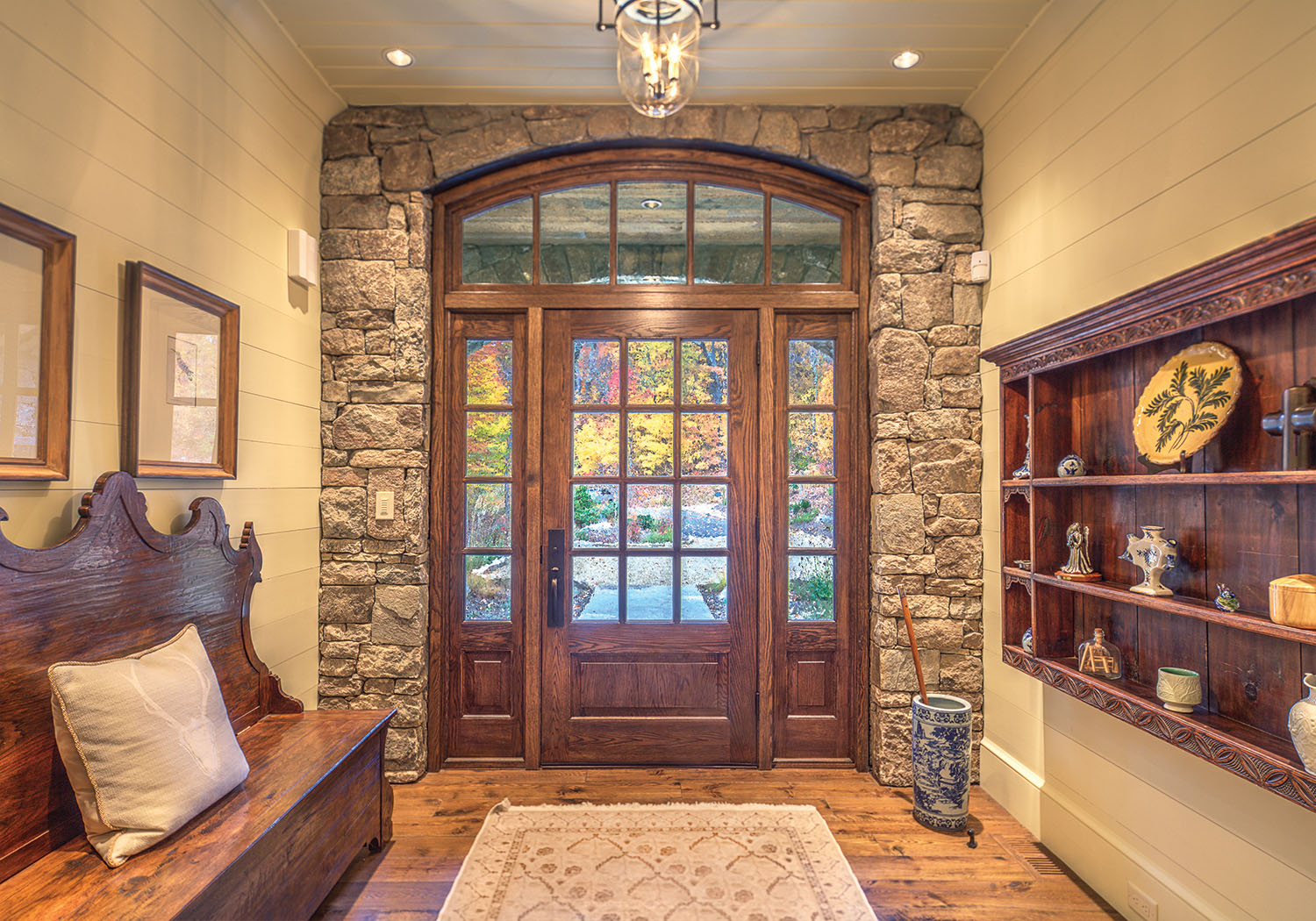 The Goldens decorated the home’s entryway with artwork and furniture acquired during their travels. Stone cladding is by Steep Creek Stoneworks. Photo by Jerry Markatos