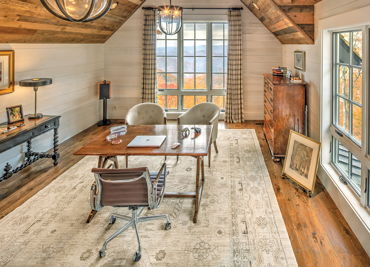 The office has a western view, overlooking cascading mountain crests in the distance. The rug atop the finished oak floors is from the Golden’s residence in Texas, as is the artwork. Photo by Jerry Markatos 