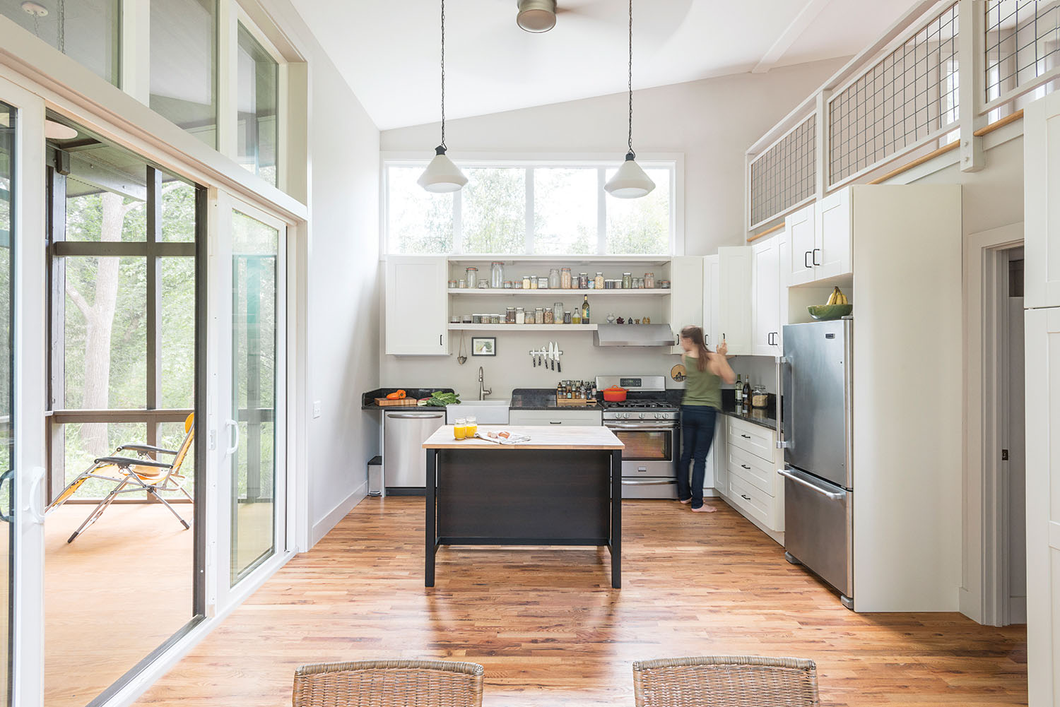 Homeowner Ali Haeffner enjoys a studio kitchen equipped with many features that open the space, including a vaulted ceiling and open shelving. Photos by Todd Crawford